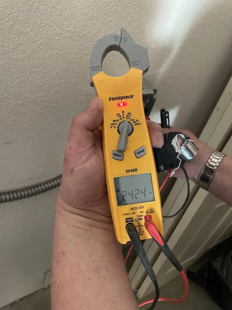 Voltage testing with clamp meter during Ceiling Fan Installation in Pierre